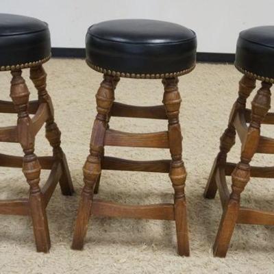 1146	3 OAK BAR STOOLS W/BLACK LEATHER SEATS & BRASS TACK ACCENTS, APPROXIMATELY 31 IN HIGH

