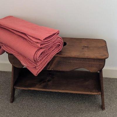 Pine bench and cotton quilted bedspread