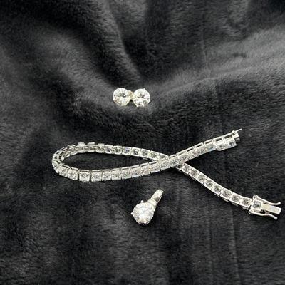 Lot #152 - Sparkling Jewelry Set -Sterling Silver Bracelet, Stud Earrings, and Pendant.