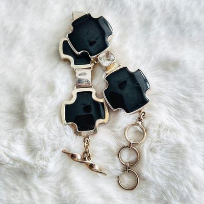 Black Onyx ornamental pieces set in a sterling silver framework, interspersed with sparkling clear Quartz crystal gemstones.