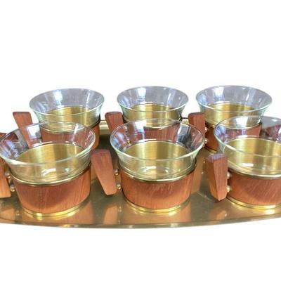 LYZE535 Schott & Gen Jena Teak And Brass Teacup Set	Set of six thin glass cups in wood and brass holders on a brass tray with wooden...