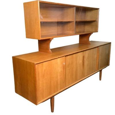 MANA600 Teak Danish Modern Credenza	 multipurpose credenza with sliding doors opening to silverware drawers and shelving, and is topped...