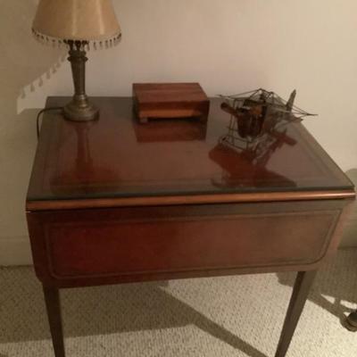 $220 leather top, drop leaf, one drawer, glass top (small chip) 28"H 28"L 21"W leaves down 39"W leaves up 