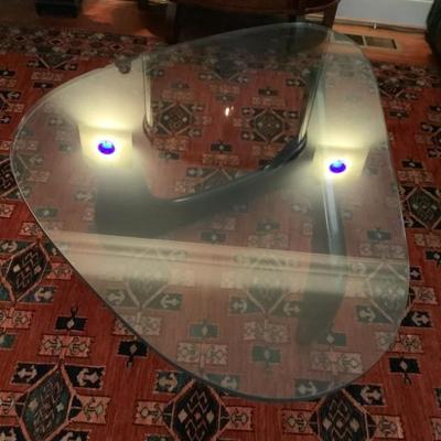 SOLD-$275 triangular shaped glass top table 16"H 50"L 36"depth