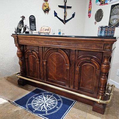 Fabulous walnut carved bar with granite top and brass rail