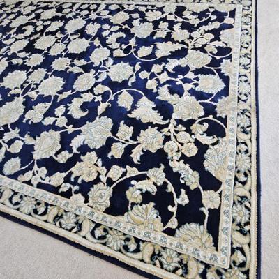 Navy and cream colored rug in master bedroom