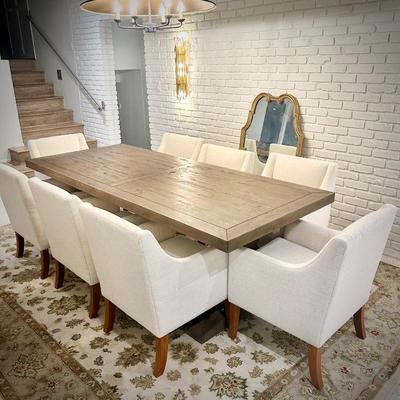 Wood trestle dining table and 8 ivory armchairs