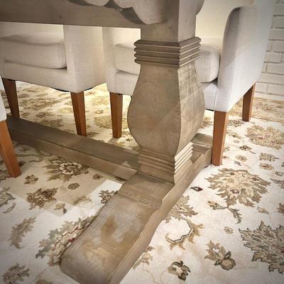 Wood trestle dining table and 8 ivory armchairs