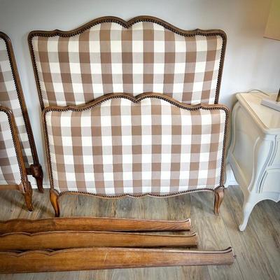 Second of two antique twin beds, recently reupholstered in brown gingham on headboard and footboard