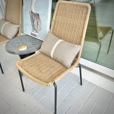Two woven chairs and two metal patio tables
