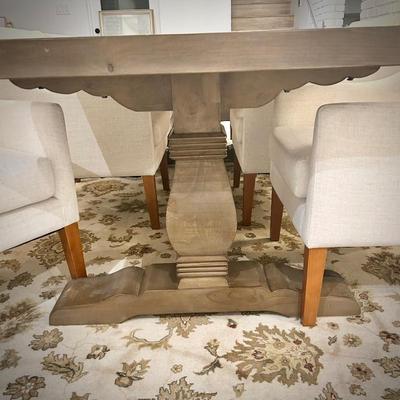 Wood trestle dining table and 8 ivory armchairs