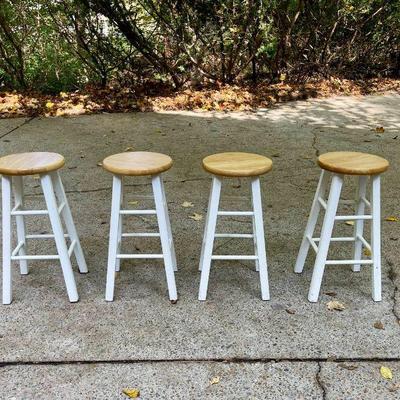 Lot 030-GAR: Four Kitchen Stools

Features: 
•	Four counter-height wooden stools with light-colored stained seats and white-painted...