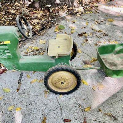 Lot 096-BH: Vintage Metal John Deere Pedal Tractor

Features: 
•	Metal John Deere Pedal tractor with pull-behind trailer
•	Well-loved and...