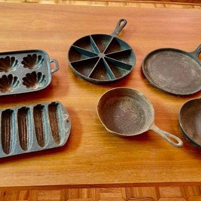 Lot 044-GAR: Antique Cast Iron Cookware

Features: 
•	Three cornbread pans
•	Small griddle pan
•	Two small frying pans 

Dimensions: N/A...