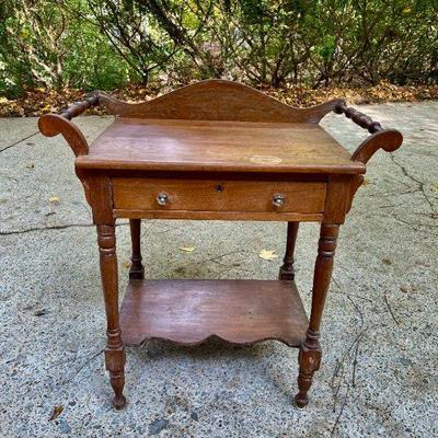 Lot 026-GAR: Antique Wash Stand

Features: 
•	Featuring turned side handles/rungs, a single storage drawer, and a lower display shelf...