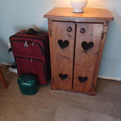 Suit cases and wood cabinets 