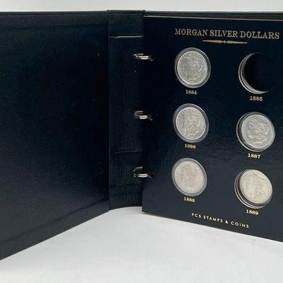 (7) Antique Morgan Silver Dollars in Album
1884, 1886, 1888, 1897, 1898, 1900, 1921. 
