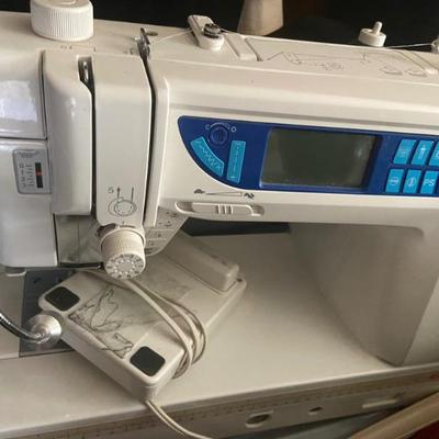 Elna Excellence 720 Sewing Machine
 (may have table knee lift)
https://www.elna.com/en-gw/data/models/Elna7300_ANG.pdf
