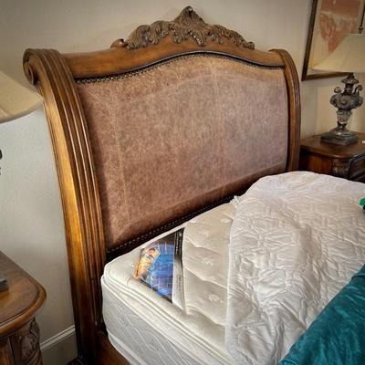 Queen bed with wood and leather headboard and footboard
