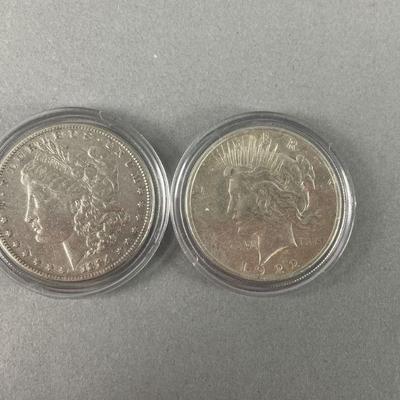 Lot 238 | 1884 Morgan and 1922 Peace Silver Dollars
