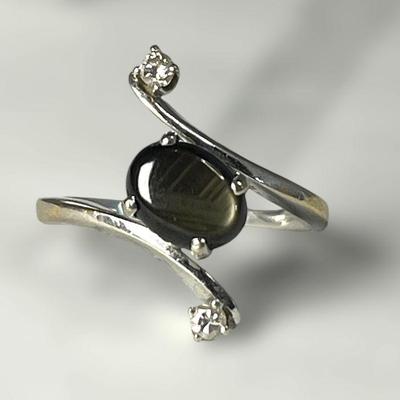 An 18k Gold Grey Star Sapphire and Diamond Ring