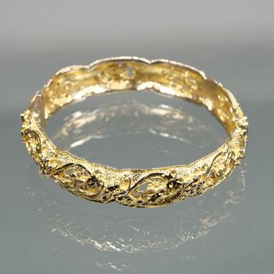 GOLD-TONE HARD BRACELET | Designed as a hinged hard bracelet decorated with flowers and scrolls pierced open work and a rope work edge...