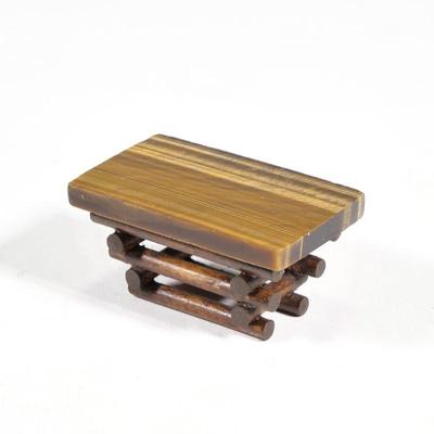 MINIATURE TIGER'S EYE TABLE | Dollhouse miniature tigers eye top low table on a stacked log base; no apparent signature. - h. 1-1/8...