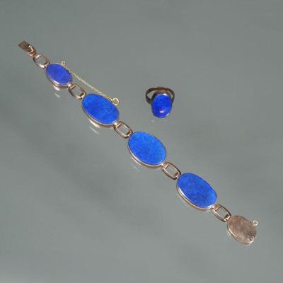 (2pc) LAPIS LAZULI JEWELRY SUITE | Comprising a bracelet of four oval lapis lazuli flat stones set in gold-tone surrounds (6.75 in,) and...