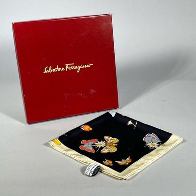 SALVATORE FERRAGAMO SILK SCARF | In original box, made in Italy, decorated with flowers and insects on a black ground within a cream...