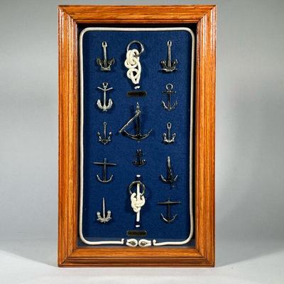 MINIATURE MODEL BOAT ANCHORS | Shadowbox framed display of miniature model ship's anchors on a blue felt ground with rope border, a...