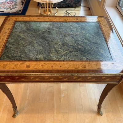 Antique inlaid center fitted marble top occasional table with a rams head on each corner and legs with hoofs feet.  L 27.3/4in | H...