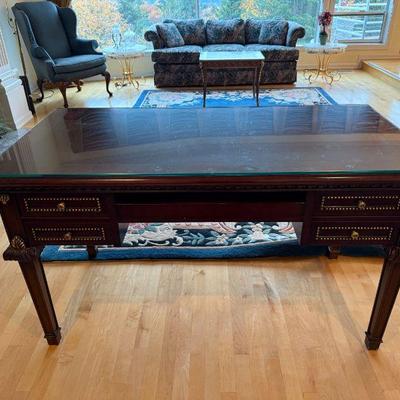 Mahogany Writing Desk with gold  trim accents and glass protective top. L 55in | D 27.1/4in | H 31.1/2in