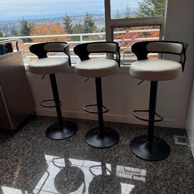 3 Adjustable, Swivel, Lift Bar Stools with Faux Leather cushions.
