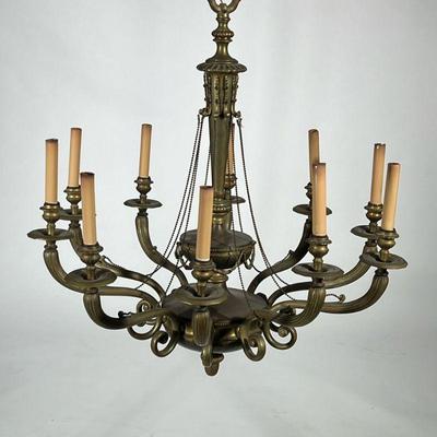 TEN LIGHT BRASS CHANDELIER | With faux candle electrified lights, scroll arms, decorated with chased garland and an acorn-form finial. -...