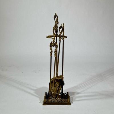 (5pc) ANTIQUE BRASS FIREPLACE TOOL SET | Four tools on a matching stand with scrolling acanthus handles. - h. 31.25 x w. 6.5 x l. 10 in

