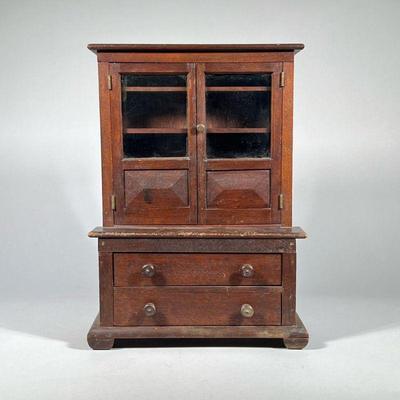 MINIATURE STEP BACK CUPBOARD | Mahogany Cupboard with two doors over two drawer. - h. 16.25 x w. 5.5 x l. 11.75 in

