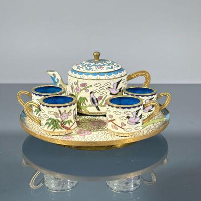 CHINESE MINIATURE CLOISONNE TEA SET | With blue, light yellow, and colored enamels, comprising a lidded teapot and four cups on a...