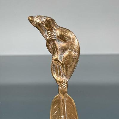 BRASS LETTER OPENER | Victorian era (or style) brass letter opener in the form of a rat perched upon the stem of a feather or leaf; no...