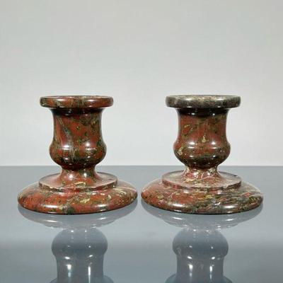PAIR STONE CANDLESTICKS | Carved/turned candlesticks in a deep red variegated marble or other stone. - h. 2.5 x dia. 3 in

