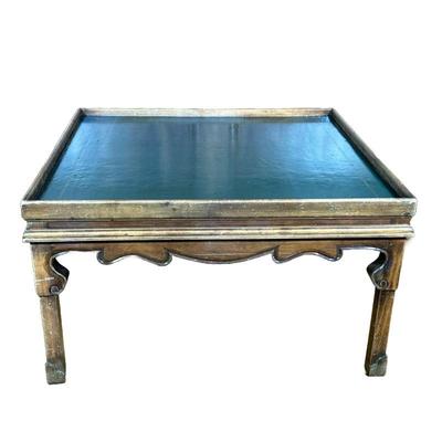 LEATHER TOP COFFEE TABLE | Low table having a green leather top with embossed gilt border and carved legs. - h. 19.25 x w. 34 x l. 34 in

