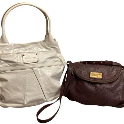 ROHU567 Two Marc Jacob’s Purses	One large, white, leather, hobo bag, one smaller, dark, purple, shoulder bag, pebble leather
