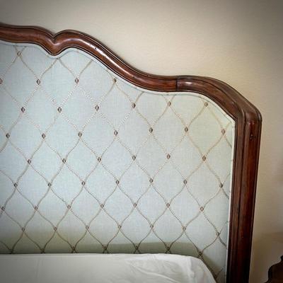 King bedframe with light Tiffany blue upholstered headboard, mattress, and linens, and light turquoise upholstered bench