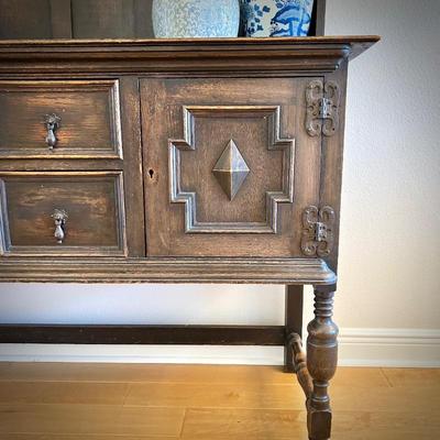 Antique sideboard with hutch. Three drawers and two cupboards. The top shelf has hooks.