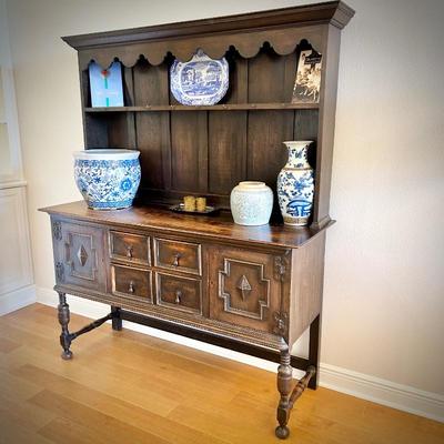 Antique sideboard with hutch. Three drawers and two cupboards. The top shelf has hooks.