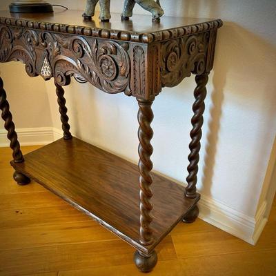 Antique European console table with barley twist legs. Fleur de Lis on the shield carved into the front. 