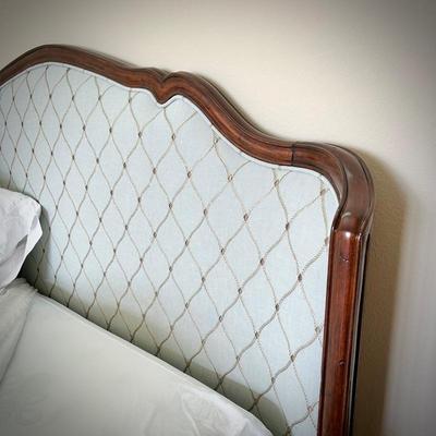 King bedframe with light Tiffany blue upholstered headboard, mattress, and linens, and light turquoise upholstered bench
