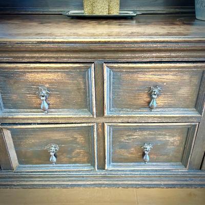 Antique sideboard with hutch. Three drawers and two cupboards. The top shelf has hooks.