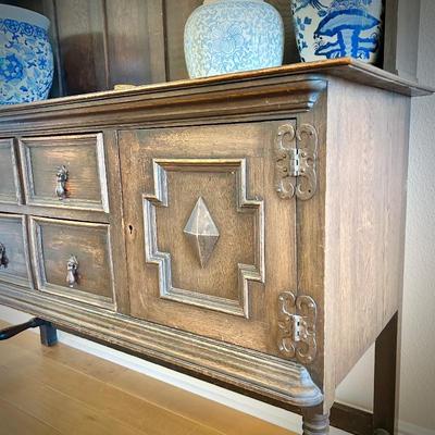 Antique sideboard with hutch. Three drawers and two cupboards. The top shelf has hooks.