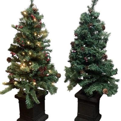 TICA710 Set of 2, Deluxe Pre-lit Urn Trees	2 decorated Christmas trees, 42" high. Metal urn base. Some signs of wear on the berry...