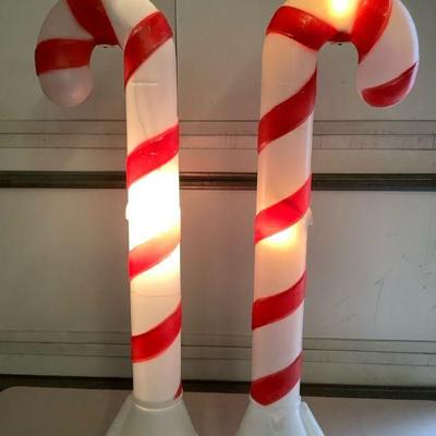 TICA614 Candy Cane Lot 2	Two candy cane outdoor decor. Tested and works.Missing top bulb on one. 
